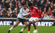 Alex Iwobi of Fulham and Ola Aina of Nottingham Forest compete for the ball during the Pre...