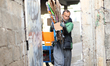 Rahaf, a 14-year-old girl, collects discarded cardboard boxes with her 52-year-old father,...