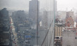 Rain and fog move into Manhattan, New York City, on March 16, 2026. Strong winds and heavy...