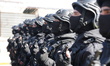 Police personnel gather at the Kafr Sousa complex before marching in an organized processi...