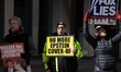 Members of the activist group Rise and Resist and their supporters gather for a weekly pro...
