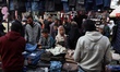 Displaced Palestinians buy from stalls at a street market ahead of Eid al-Fitr, the holida...