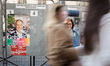 Posters of Paris Municipal Elections candidates Emmanuel Gregoire and Rachida Dati are dis...