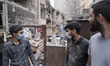 A group of Iranian volunteers work among the ruins of a building near a police station in...