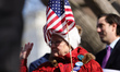 A woman holds a U.S. flag during a rally and press conference against the SAVE America Act...