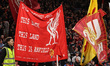 Liverpool fans wave flags in the Kop during the UEFA Champions League last 16 second leg m...