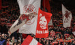 Liverpool fans wave flags in the Kop during the UEFA Champions League last 16 second leg m...