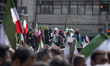 Iranian mourners holding national flags participate in a funeral for Ali Larijani, Secreta...