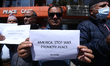 Activists from the Human Rights and Peace Society hold placards during a protest calling f...