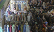 People shop for clothes ahead of Eid al-Fitr celebrations at Tanah Abang Market in Jakarta...