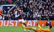 Leon Bailey of Aston Villa turns to celebrate as Lille OSC's goalkeeper, Berke Ozer, is on...