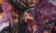 People attend Eid al-Fitr prayers at Badshahi Mosque in Lahore, Pakistan, on March 21, 202...