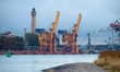 Two yellow port cranes at Nabrzeze Chemikow in the port area near the lighthouse are seen...