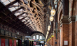 Interior view of the passenger hall of Copenhagen Central Station with columns, roof struc...