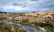 A panoramic view from Mirador del Valle shows the historic city of Toledo across the Tagus...