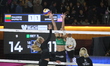 Sara Hughes of the United States spikes the ball against Aine Raupelyte of Lithuania durin...