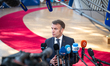 France's President Emmanuel Macron speaks to journalists as he arrives prior to the Europe...