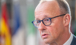 German Chancellor Friedrich Merz speaks to journalists as he arrives prior to the European...
