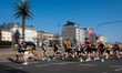 Runners pass the palm tree installation at Charles de Gaulle Roundabout during the 20th Wa...