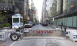 NYPD police vehicles and barricades with STOP sign around the streets surrounding Trump To...