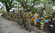 Security personnel stand guard outside the deputy commissioner's office during the Assam S...