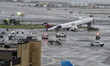 NTSB investigators gather at the scene where an Air Canada jet and a Port Authority fire t...