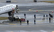 NTSB investigators work at the scene where an Air Canada jet and a Port Authority fire tru...