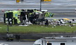 NTSB investigators work at the scene where an Air Canada jet and a Port Authority fire tru...