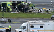 NTSB investigators work at the scene where an Air Canada jet and a Port Authority fire tru...