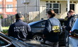 ATF federal agents and crime scene investigators work at the scene where a U.S. Park Polic...