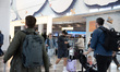 Passengers arrive at LaGuardia Airport in New York City, United States, on March 24, 2026,...