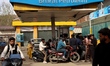 People refuel their vehicles at a petrol station in Baramulla, Jammu and Kashmir, India, o...