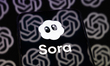 The Sora logo appears on the screen of a smartphone placed on a reflective surface onto wh...