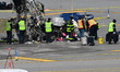 Investigators with the FBI, NTSB, and officials process the scene of a collision between a...