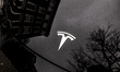 The Tesla logo is seen in central London as the sky and residential houses reflect in the...