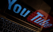 In this photo illustration the YouTube logo is shown on a computer screen as Meta and YouT...
