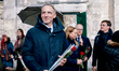 French politician Raphael Glucksmann holds a rose as he arrives to attend the funeral of f...