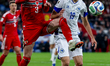 Neco Williams of Wales and Kerim Alajbegovic of Bosnia and Herzegovina compete for possess...