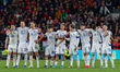 Bosnia and Herzegovina players watch during the penalty shootout in the FIFA World Cup Pla...