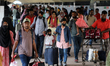 Passengers crowd the concourse at Kamalapur Railway Station as they return to Dhaka, Bangl...