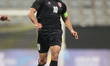Mousa Altamari, a Jordanian player, dribbles the ball during a friendly match between Jord...