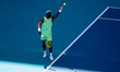 Frances Tiafoe of the United States serves against Jannik Sinner of Italy during their qua...
