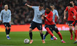 Manuel Ugarte of Uruguay is challenged by Djed Spence of England during the International...