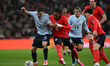 Manuel Ugarte of Uruguay is challenged by Djed Spence of England during the International...