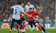 Jarrod Bowen of England is challenged by Ronald Araujo and Manuel Ugarte of Uruguay during...