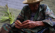 A member of the Palmeros de Chacao makes a palm cross during the harvest of palms that wil...