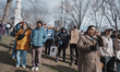 A woman wipes her eyes during the No Kings rally in Boston, United States, on March 28, 20...