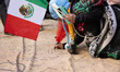 Participants write personal messages onto a large U.S. Constitution that lies along Sevent...