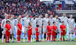 The Iceland team stands and sings their national anthem before the start of an internation...