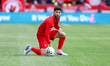 Team Canada midfielder Jonathan Osorio kneels on the ground after being fouled by an Icela...